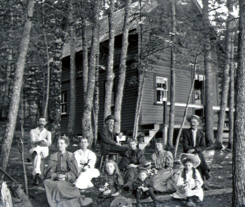 Posing for the camera in front of one of the Lakeside cottages was indeed a special occasion, since everyone is decked out in their Sunday-go-to-meeting clothes. Seated in the center in back is Charles Richardson, a much older man than we observed in the earlier tintype. Frank Judkins is on the right wearing a straw hat, and we have no trouble picking out Nina Judkins at the front of the picture. 